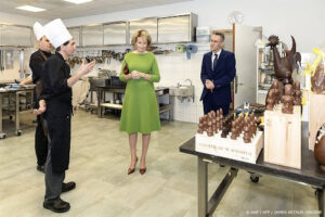 Koningin Mathilde krijgt chocola bij bezoek aan hotelschool